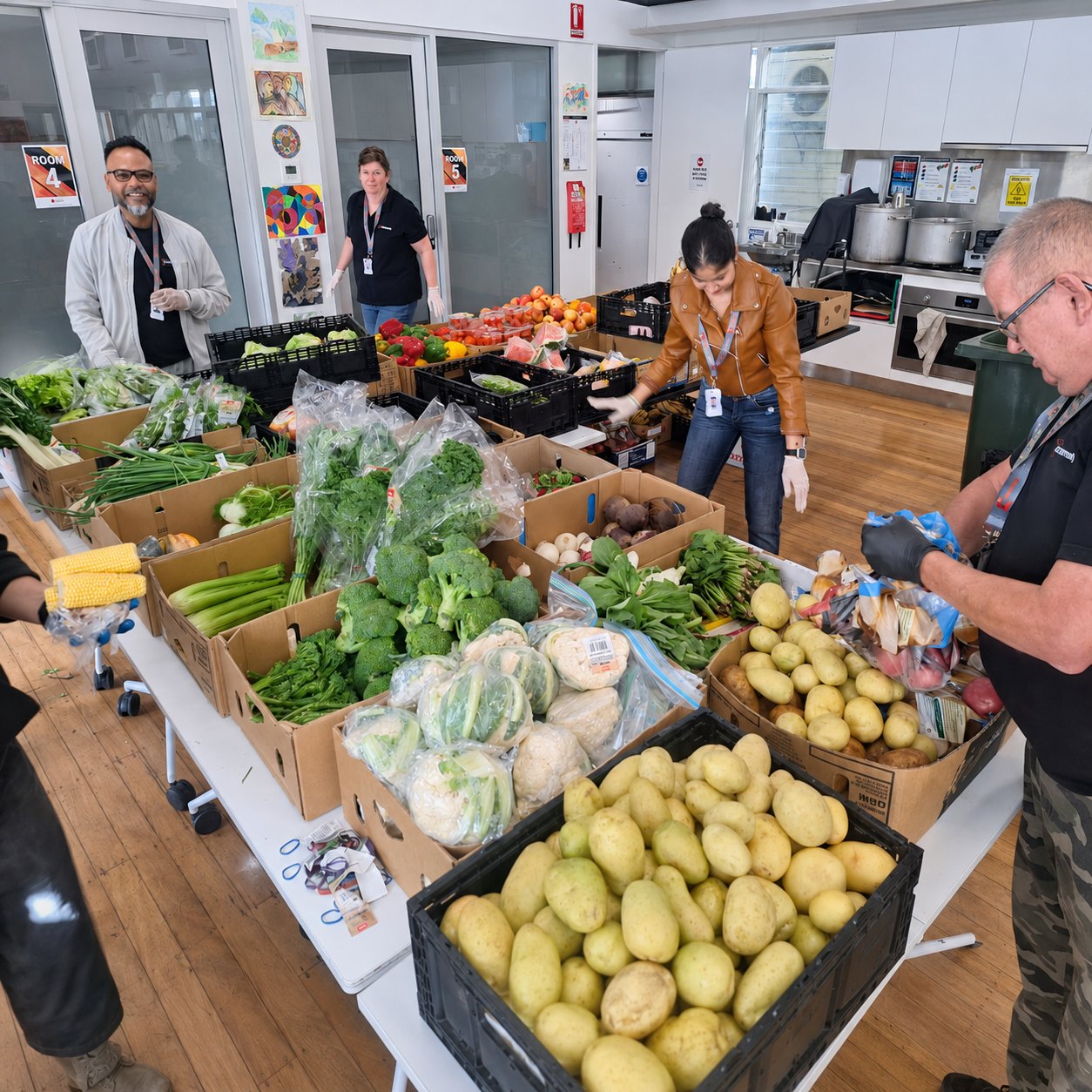 Volunteers packing crates of fresh produce at a Street Care distribution